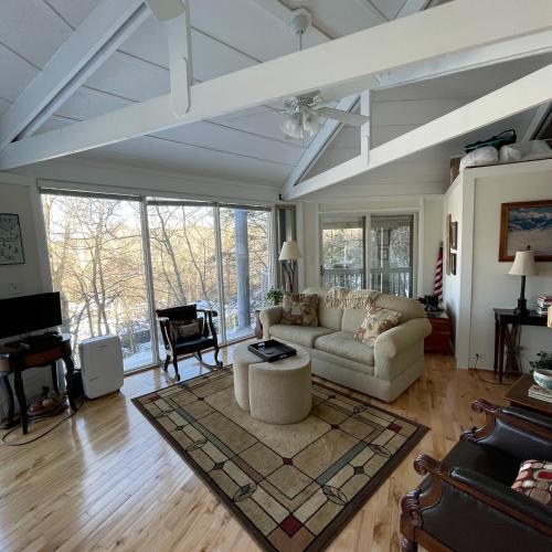 a living room with a couch and a table at Slopesider 23B condo in Sugar Mountain