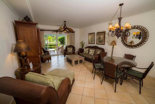 a living room filled with furniture and a table at Del Mar 3N 3 bdr Garden View in Los Suenos in Herradura
