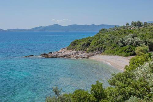 a beach in the middle of a body of water at Seafront Paradise in Glífa