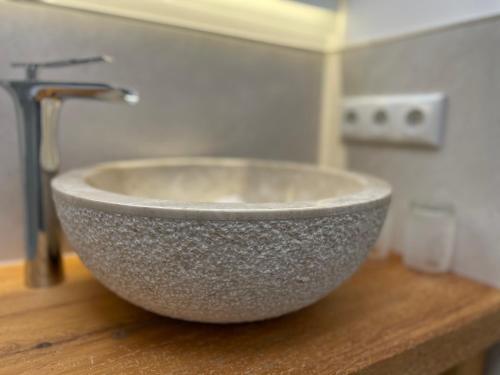 a bowl sink on top of a wooden counter at Landhaus Kössel in Füssen