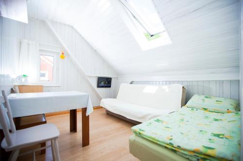 a bedroom with a bed and a sink in a attic at u Emilii pokoje gościnne in Niechorze