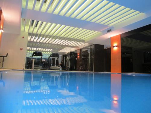 a large swimming pool in a large building at Victory Hotel & Spa Istanbul in Istanbul