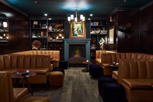 a waiting room with couches and a fireplace at The Oliver Hotel Knoxville, by Oliver in Knoxville