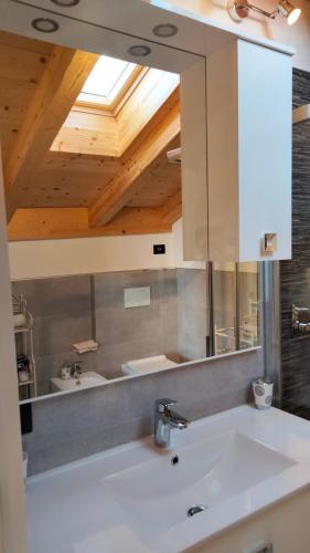 a bathroom with a sink and a mirror at Casa Al.Ma in Domaso