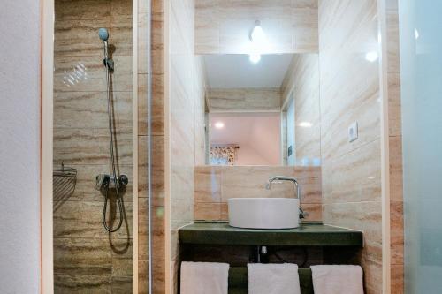 a bathroom with a sink and a shower at Kádárház in Vlăhiţa