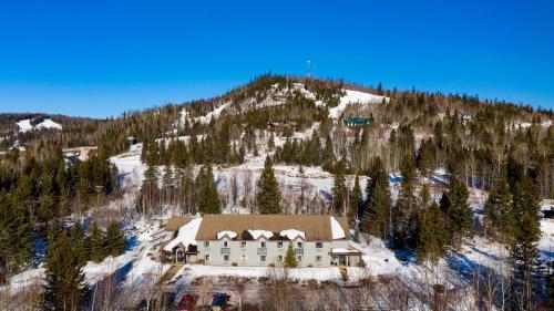 a building on the side of a snow covered mountain at Mountain Inn at Lutsen in Lutsen