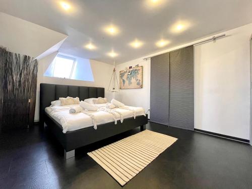 a bedroom with a large bed and a rug at B OUR GUEST at NEW FLAT NEARBY DRESDEN !!!POOL!!! in Frauendorf