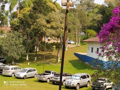 a group of cars parked in a grass field at Atma Anna in Piedade
