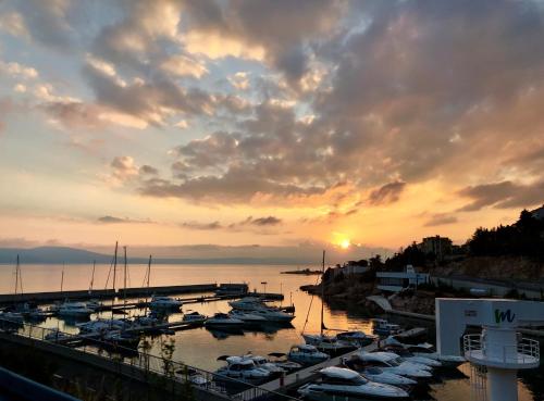 a group of boats docked in a marina at sunset at LOFT-Beach-apartments RATKO in Novi Vinodolski