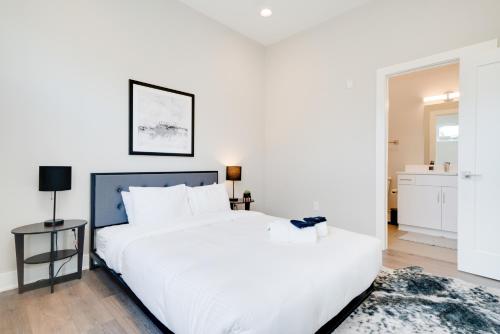 a bedroom with a large white bed with white pillows at Mason Lofts at West End in Nashville