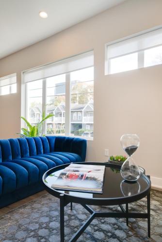 a living room with a blue couch and a table at Mason Lofts at West End in Nashville