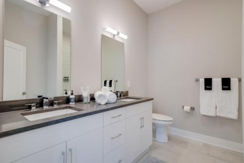 a white bathroom with a sink and a toilet at Mason Lofts at West End in Nashville