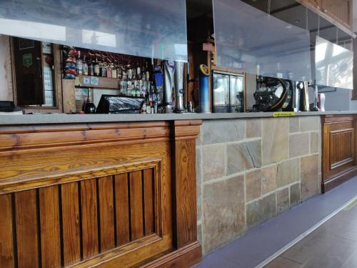 a bar with a wooden counter in a room at Croxdale Inn in Durham