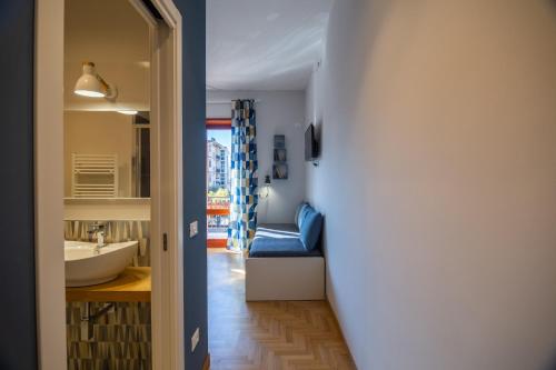 a hallway leading to a bathroom with a sink and a bed at Locazione turistica a Monterotondo in Monterotondo