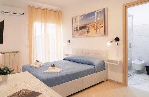 a bedroom with a bed and a bathroom at South Valley in Agrigento