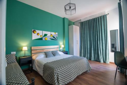 a bedroom with a bed and a blue wall at Locazione turistica a Monterotondo in Monterotondo