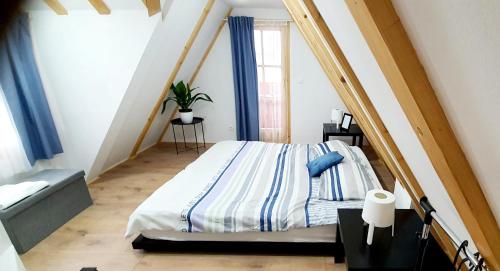 a bedroom with a bed with blue and white sheets at Villa Mila in Pribislavec
