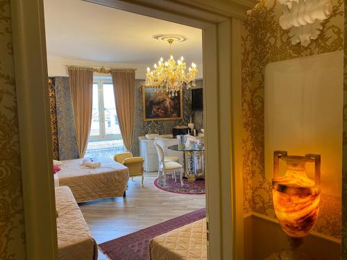 a living room with a couch and a dining room at Royal Olympus Verona in Verona