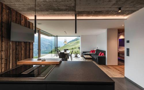 a kitchen and living room with a view of the mountains at Chalet in Naturno