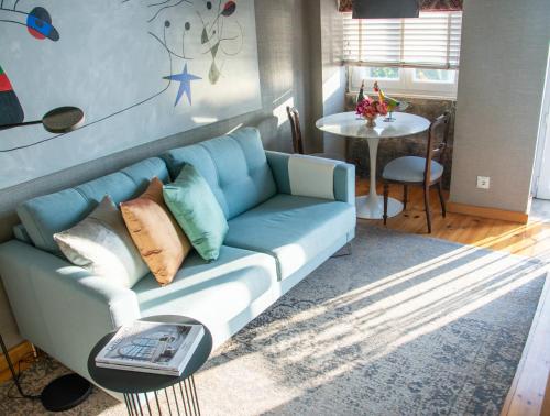 a blue couch in a living room with a table at Apartment by the Sea in Porto