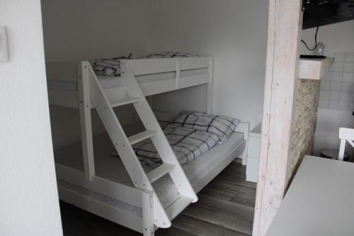 a white bunk bed with a ladder in a room at Ubytovanie Ľaľa in Spišské Tomášovce