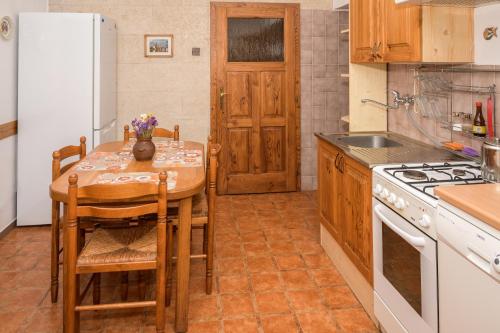 a kitchen with a table and chairs and a refrigerator at Agroturistika - "Domeček u oveček" in Horní Těrlicko