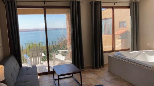a bathroom with a tub and a view of the ocean at Gran Despertar El Faro Hotel in Santiaguillo
