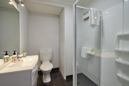 
a bathroom with a toilet, sink, and shower at The White Morph - Heritage Collection in Kaikoura

