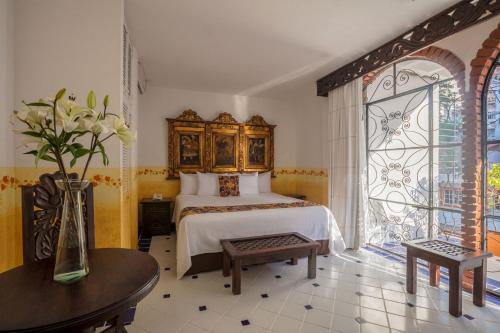 a bedroom with a bed and a large window at Casa Doña Susana in Puerto Vallarta