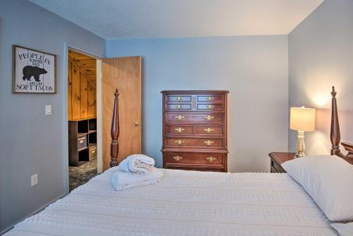 a bedroom with a large bed with a dresser and a drawer at Loon Mountain Condo with Pool and Game Room Access! in Lincoln