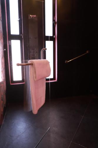 a towel hanging on a towel rack in a bathroom at Casa Rosa Hotel & Spa in San Cristóbal de Las Casas