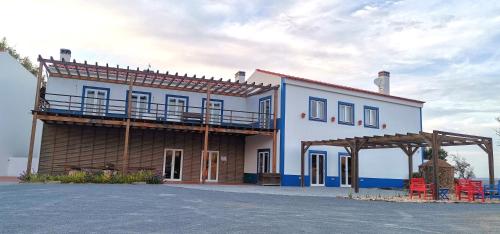 a blue and white building with a balcony on it at Monte Corgo da Vaca in Sabóia