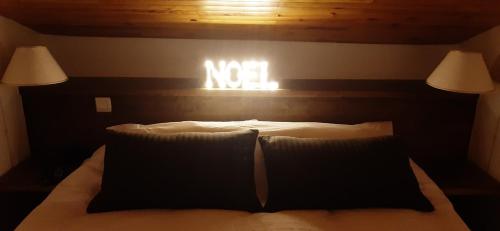 a bedroom with a bed with a sign on the wall at Luxury Apartment MONTCHAVIN in Montchavin