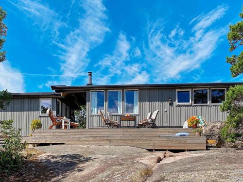 a home with a large deck with chairs on it at 9 person holiday home in Vester y in Hauge