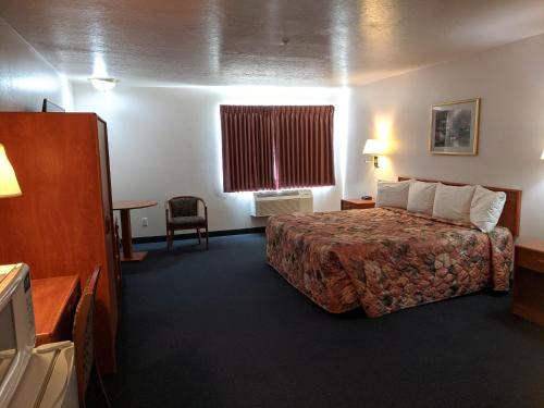 a hotel room with a bed and a window at Aquarius Inn in Bicknell