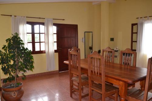 a dining room with a wooden table and chairs at Posada Rivera in San Salvador de Jujuy