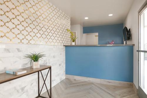 a bar in a room with a blue wall at Torch Lite Inn at the Beach Boardwalk in Santa Cruz