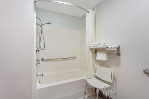 a bathroom with a shower, toilet and sink at Super 8 by Wyndham Bedford in Bedford