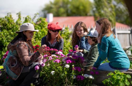a group of women looking at flowers in a garden at Estancia Cerro Guido in Torres del Paine
