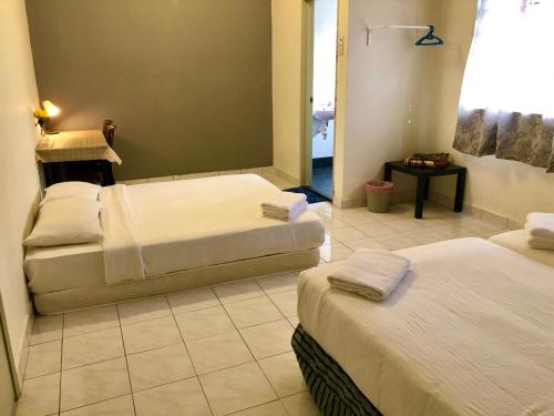 Postel nebo postele na pokoji v ubytování Bentong Makmur Guesthouse