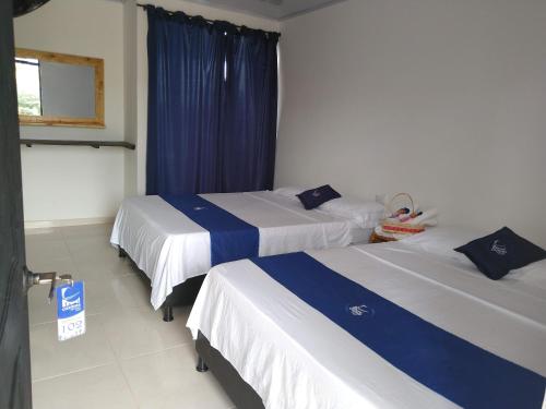 Ein Bett oder Betten in einem Zimmer der Unterkunft Cosmos Tatacoa Hotel