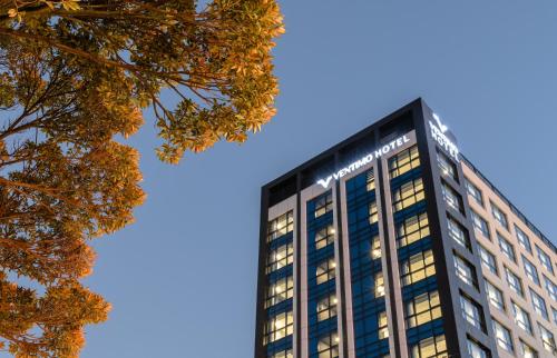 a tall building with lights on top of it at Ventimo Hotel & Residence Jeju in Jeju