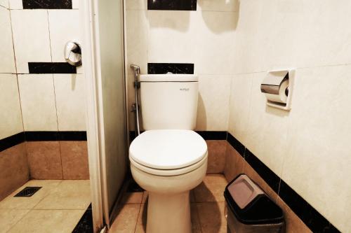 a bathroom with a white toilet in a stall at Bendungan Hilir Residence in Jakarta