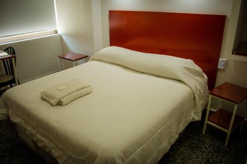 a hotel room with a bed with a towel on it at WISZ-V in Belén