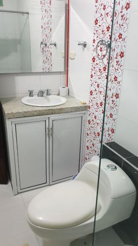 een badkamer met een toilet en een wastafel bij CasaHotel Barrancabermeja in Barrancabermeja