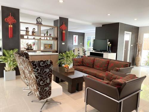a living room with a couch and a table at 14 Place Sukhumvit Suites in Bangkok