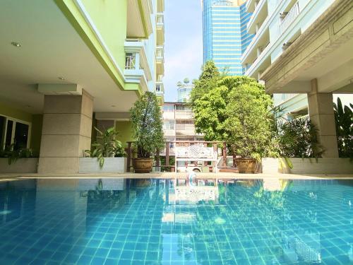a swimming pool in the middle of a building at 14 Place Sukhumvit Suites in Bangkok