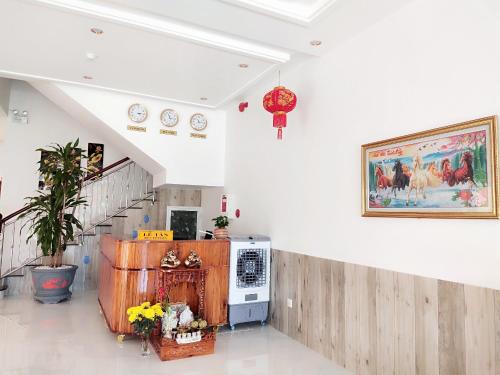 a room with a staircase and a painting on the wall at Sao Mai hotel in Con Dao