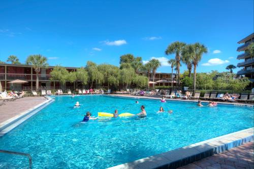 a group of people swimming in a swimming pool at Rosen Inn International Near The Parks in Orlando