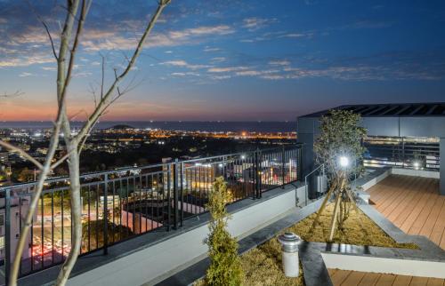 a view from the balcony of a building at night at Ventimo Hotel & Residence Jeju in Jeju
